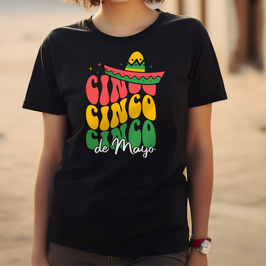 Person wearing a black t-shirt with 'Cinco de Mayo' colorful text design.