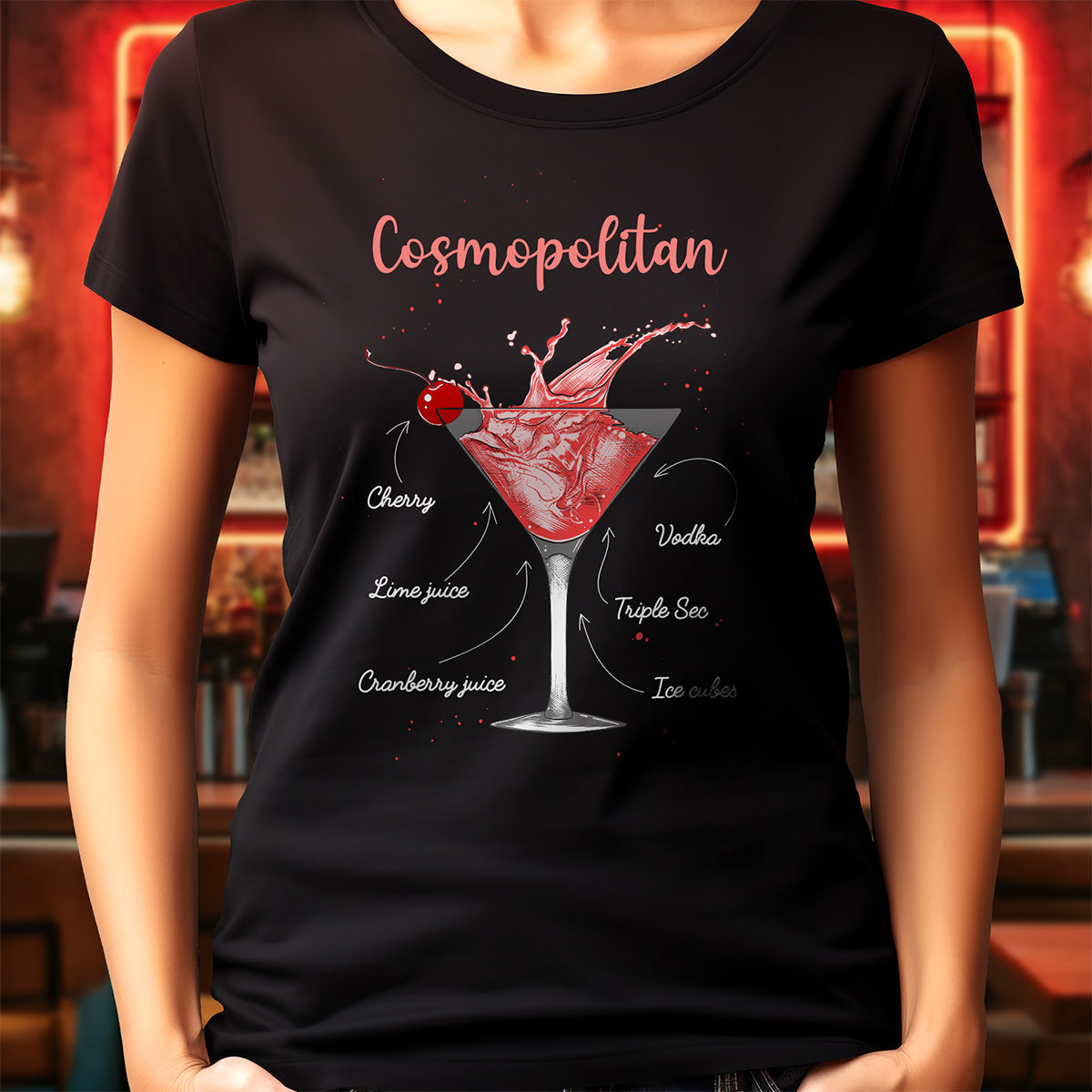 Black t-shirt with a cosmopolitan cocktail graphic and text, worn by a person in a bar setting.
