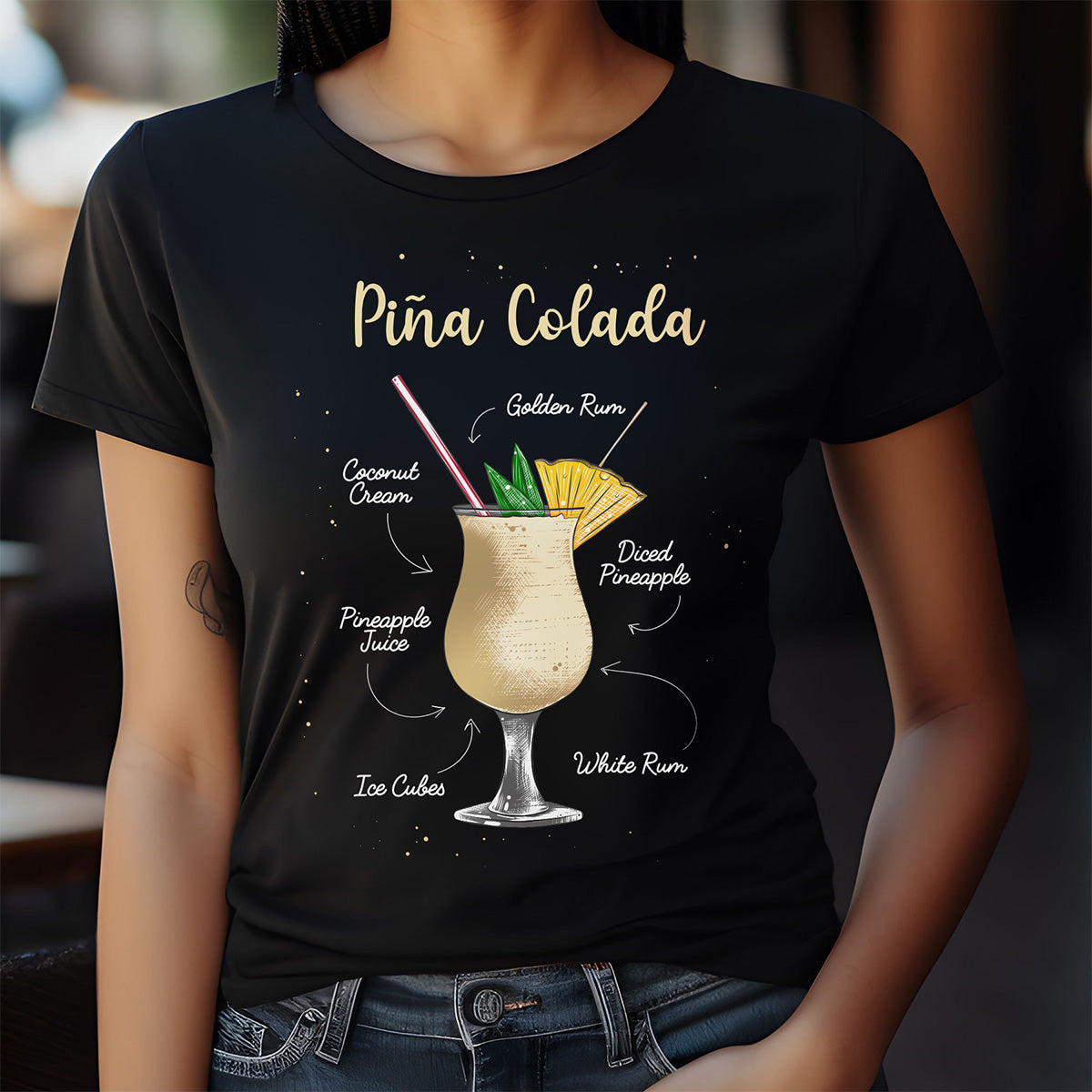 Black t-shirt with Pina Colada graphic and ingredients on a blurred background