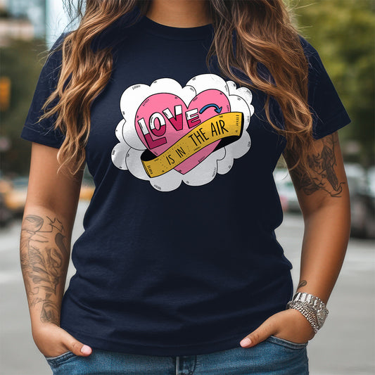 Person wearing a navy blue t-shirt with a colorful graphic design of hearts and text.