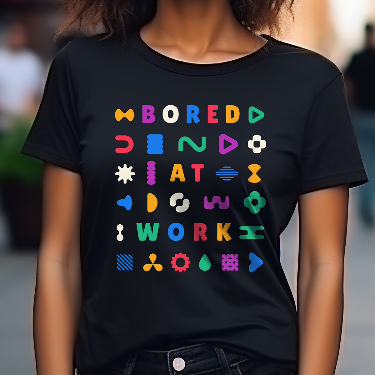 Person wearing a black t-shirt with colorful text and symbols.